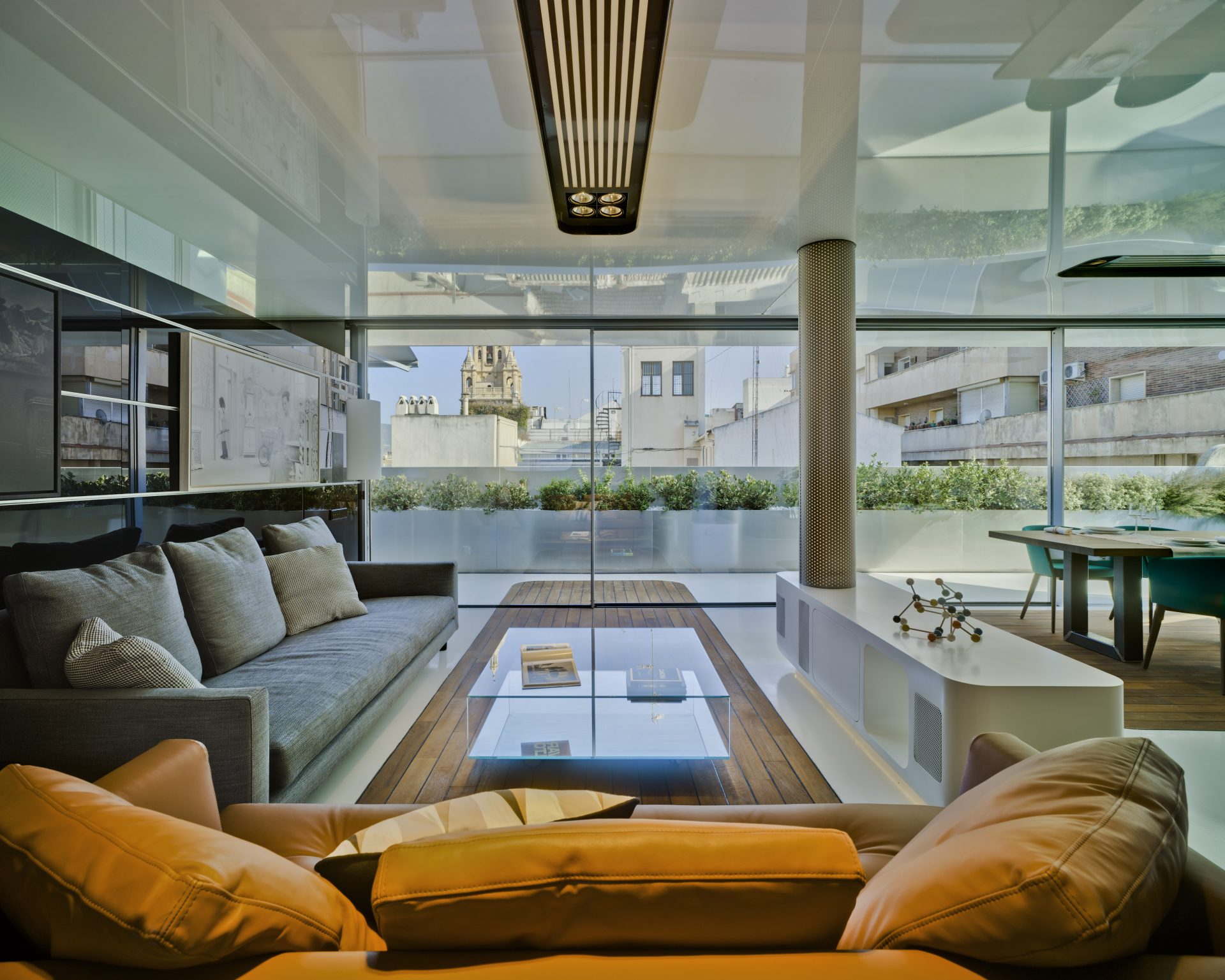 modern living room with closed slime frame sliding doors leading onto an outdoor space during the day