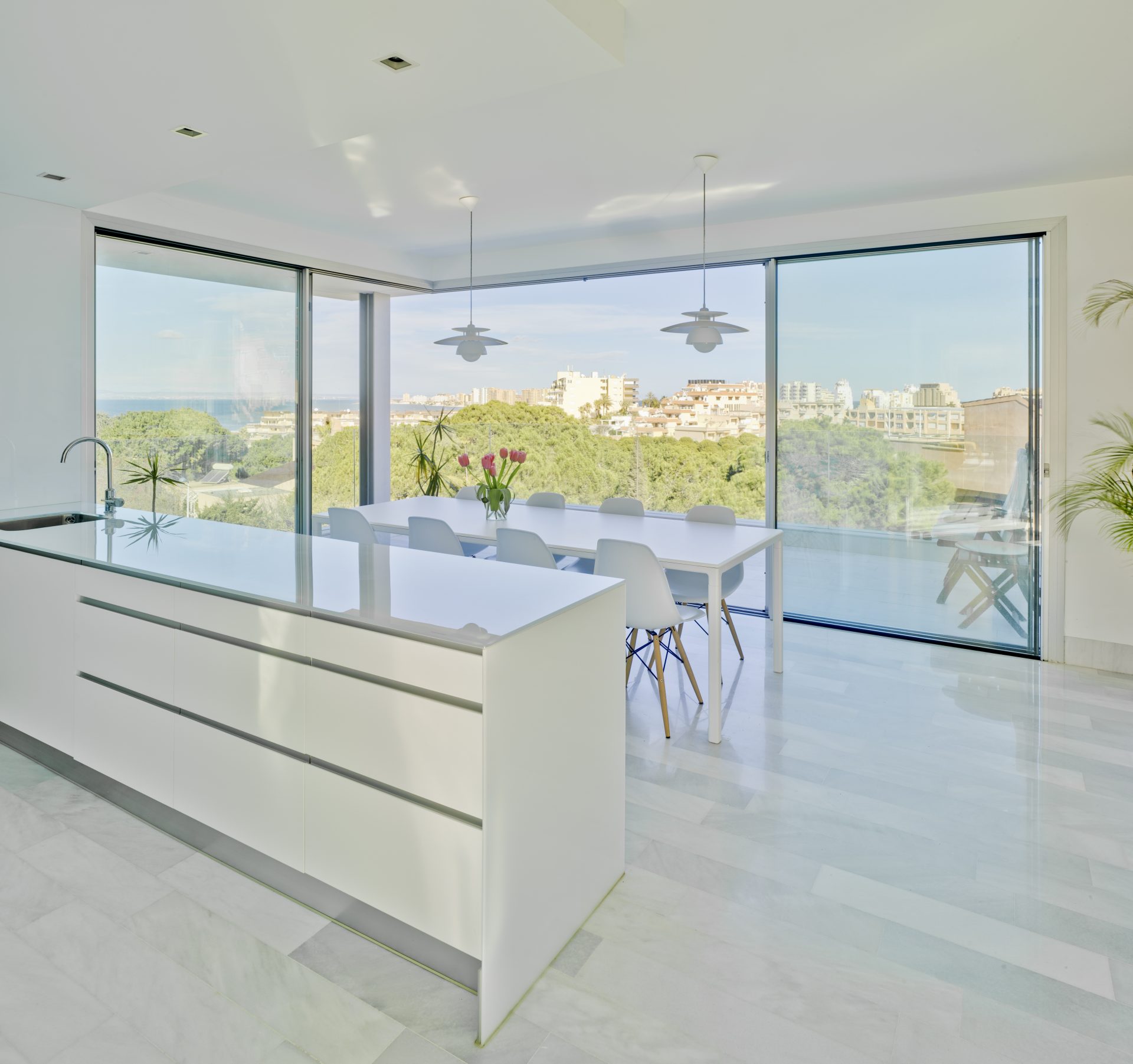 Open slim sliding doors off a dining area leading onto an outdoor area
