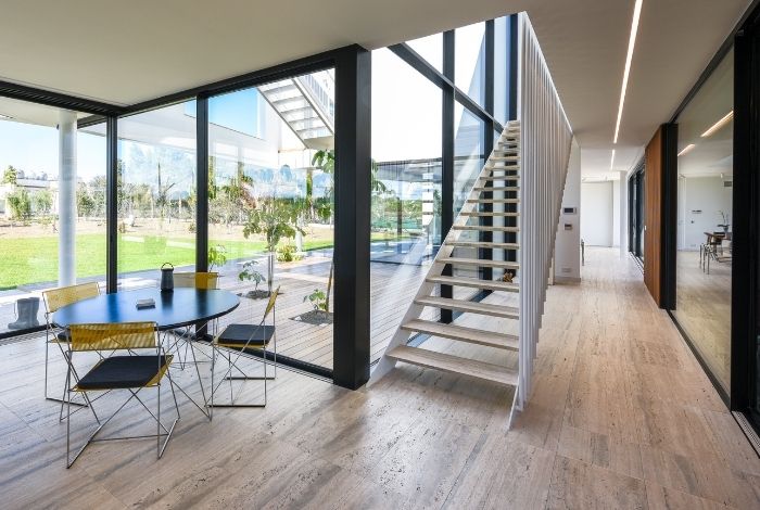 interior of a luxury modern holiday villa with multiple sliding doors and oversized glazing