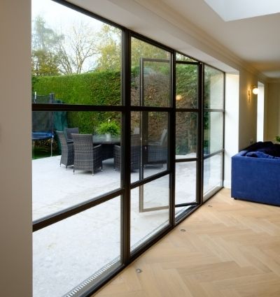 steel look casement patio doors open with outdoor seating area