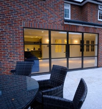 steel look casement patio doors with outdoor seating area