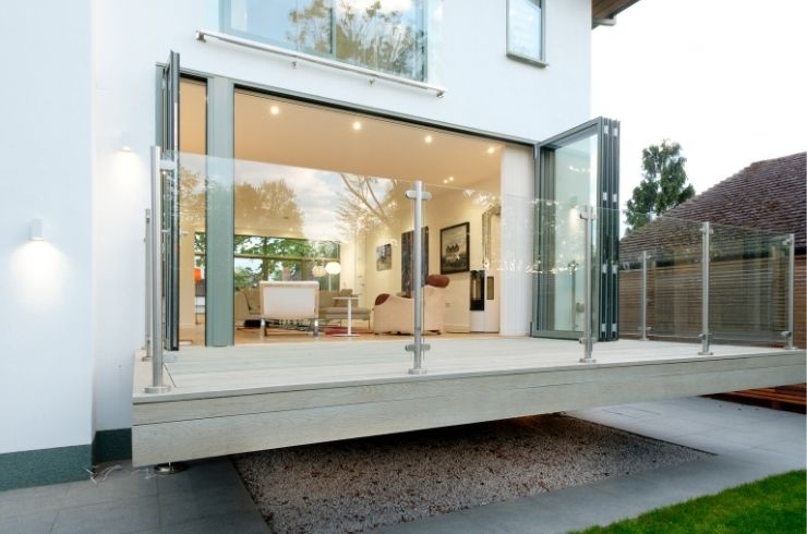 floating terrace with a glass balustrade and grey aluminium bifold door with a traffic door