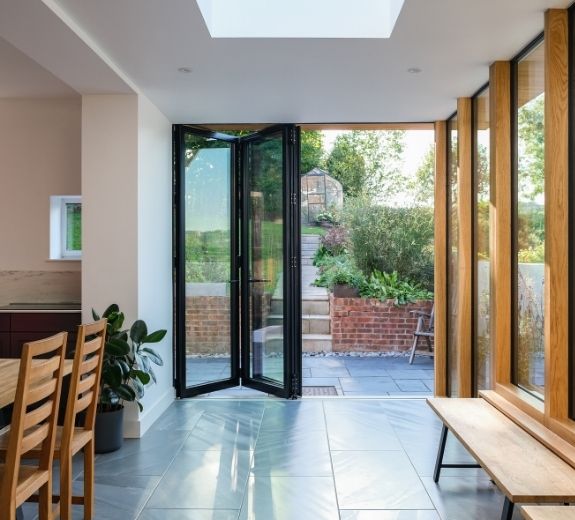 side infill extension with a modern kitchen diner area and an aluminium bifolding patio door side infill extension with a modern kit