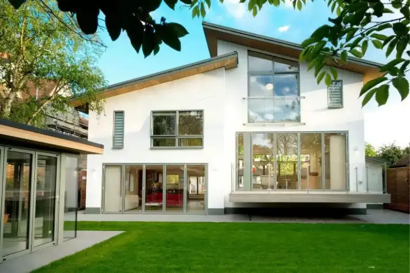 multiple sieger bifold doors used in a new build home with unique green patio door frames