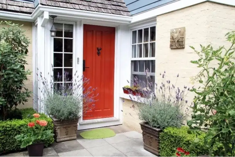 red aluminium traditional style front door on a countryside home