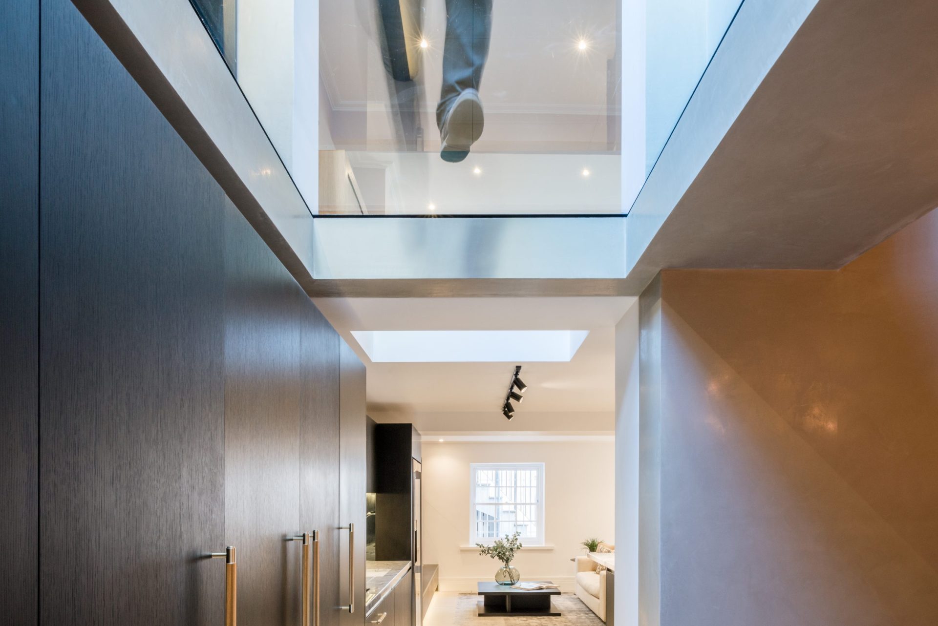 a human foot tests out a walk on floorlight - structural glass - britten street - sieger systems
